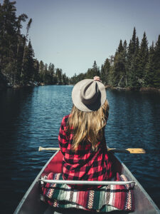 Photo of a Woman Canoeing. Safe Travel Exists at Tallpine!